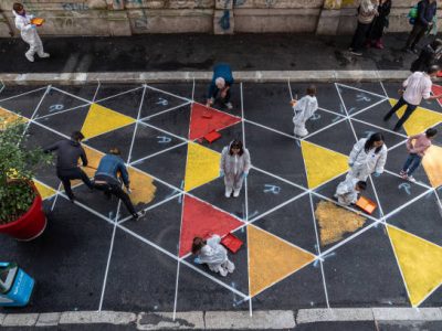 MILAN, ITALY - OCTOBER 05: Volunteers and schoolchildren work to paint the asphalt while redesigning a pedestrianised school street, part of the project “Piazze Aperte” in via Bernardino de Conti on October 05, 2024 in Milan, Italy. Piazze Aperte (“Open Squares”) is a program of the City of Milan - developed with Bloomberg Associates and the Global Designing Cities Initiative - using the approach of  “tactical urbanism” to enhance public urban spaces, turning them into community gathering places, extending pedestrian areas and promoting sustainable forms of mobility. To date, the Municipality of Milan has implemented more than 60 tactical interventions and continues to plan new ones. (Photo by Emanuele Cremaschi/Getty Images)